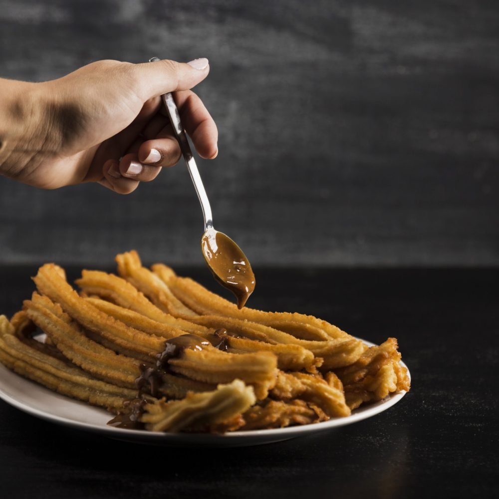 hand-spoon-with-delicious-fried-churros